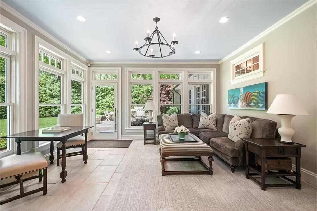 Living room with couches and large glass windows.
