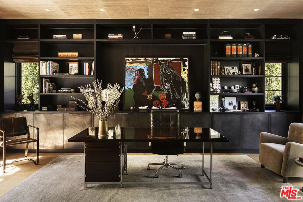 A home office with a TV, shelves, a cabinet, a desk, and chairs.