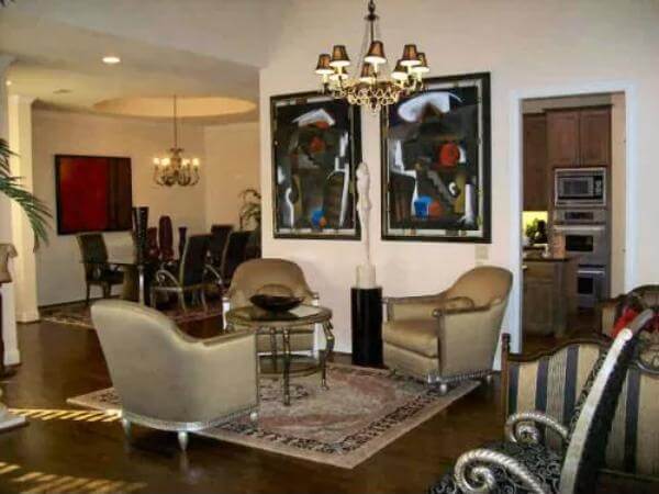 Family room with round back chairs and a round coffee table over the area rug.