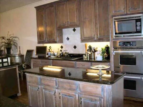 Kitchen with rustic cabinets and a matching island.