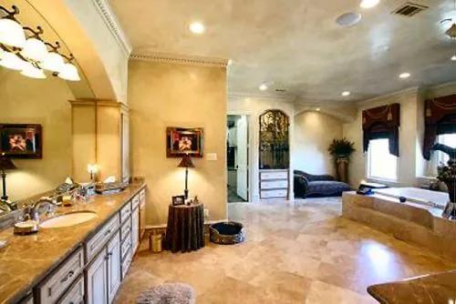 The primary bathroom includes a large vanity topped by a frameless mirror.