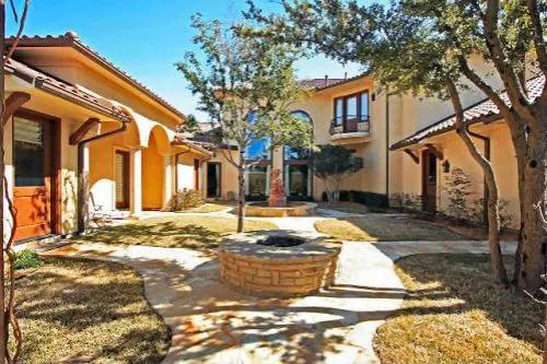 Courtyard with a fire pit and a fountain.