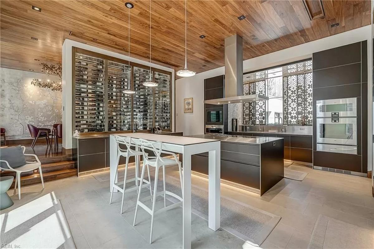 Kitchen with custom cabinetry, a counter breakfast bar and a center island prep area.