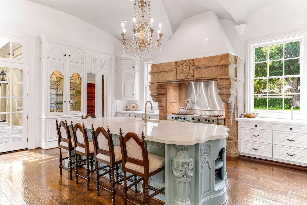 Kitchen with custom cabinetry, a counter breakfast bar and a chandelier.