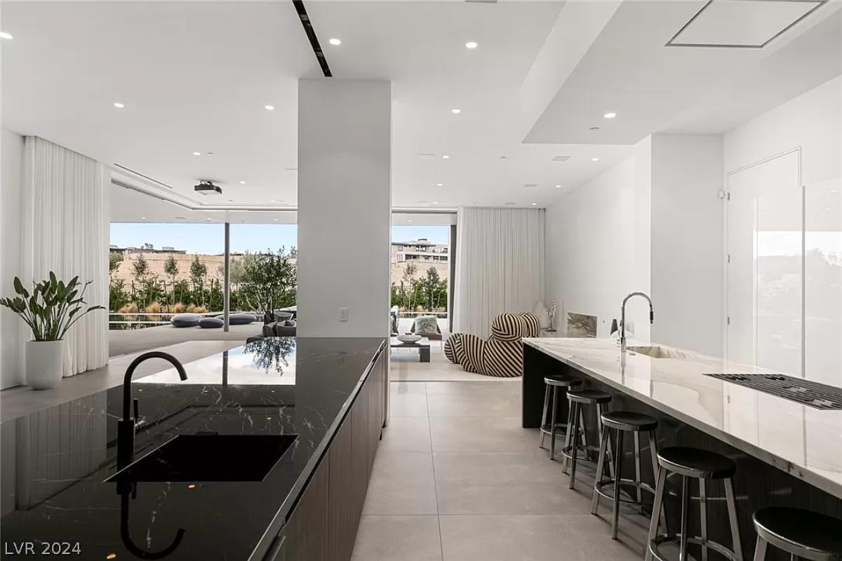 Kitchen with a counter breakfast bar and an island prep area.