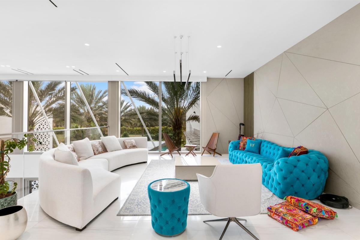 Living room with marble flooring and couches.