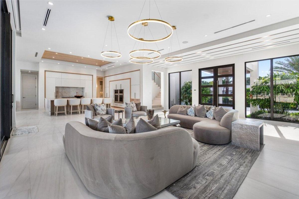 Living room with couches and custom lighting.