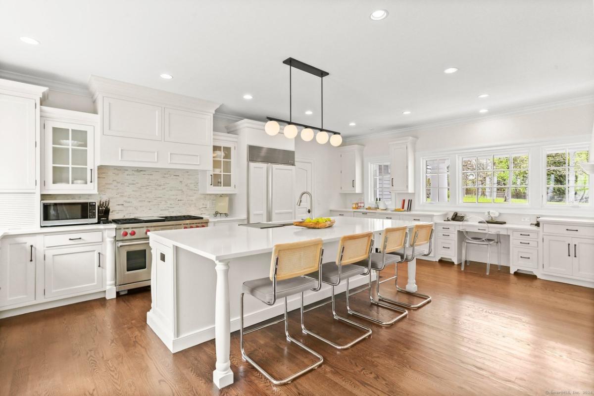 Kitchen with custom cabinetry and a counter breakfast bar.
