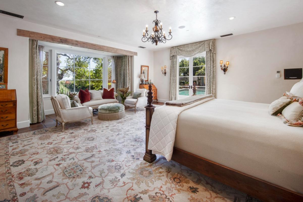 Bedroom with a chandelier and glass doors.