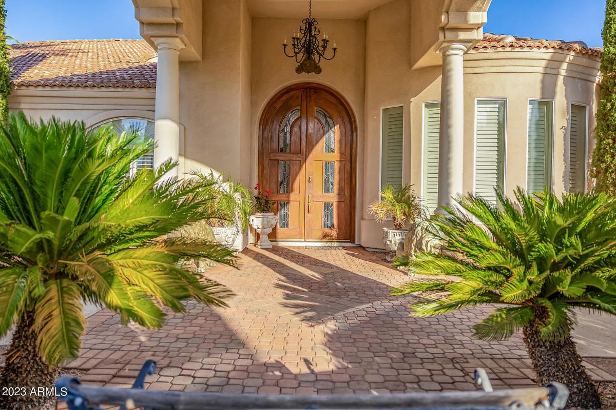 Front entry of the mansion with a large wood door.