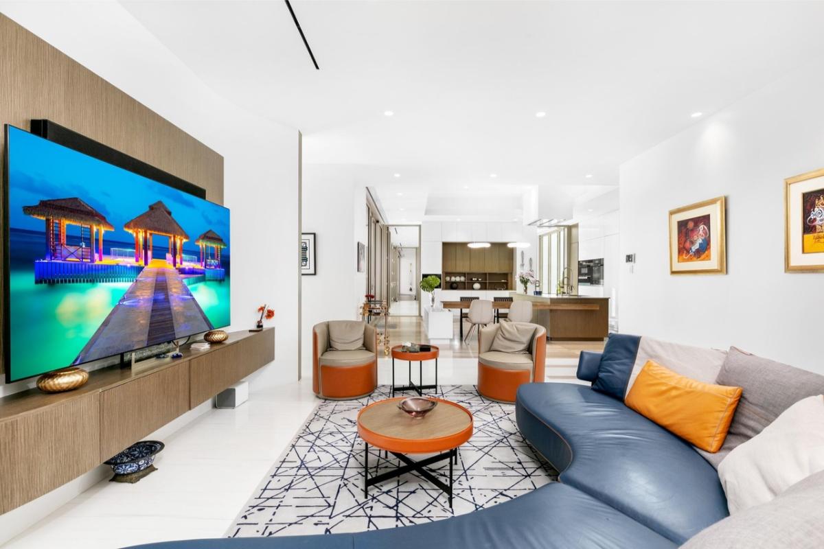 Living room with a TV and couches.