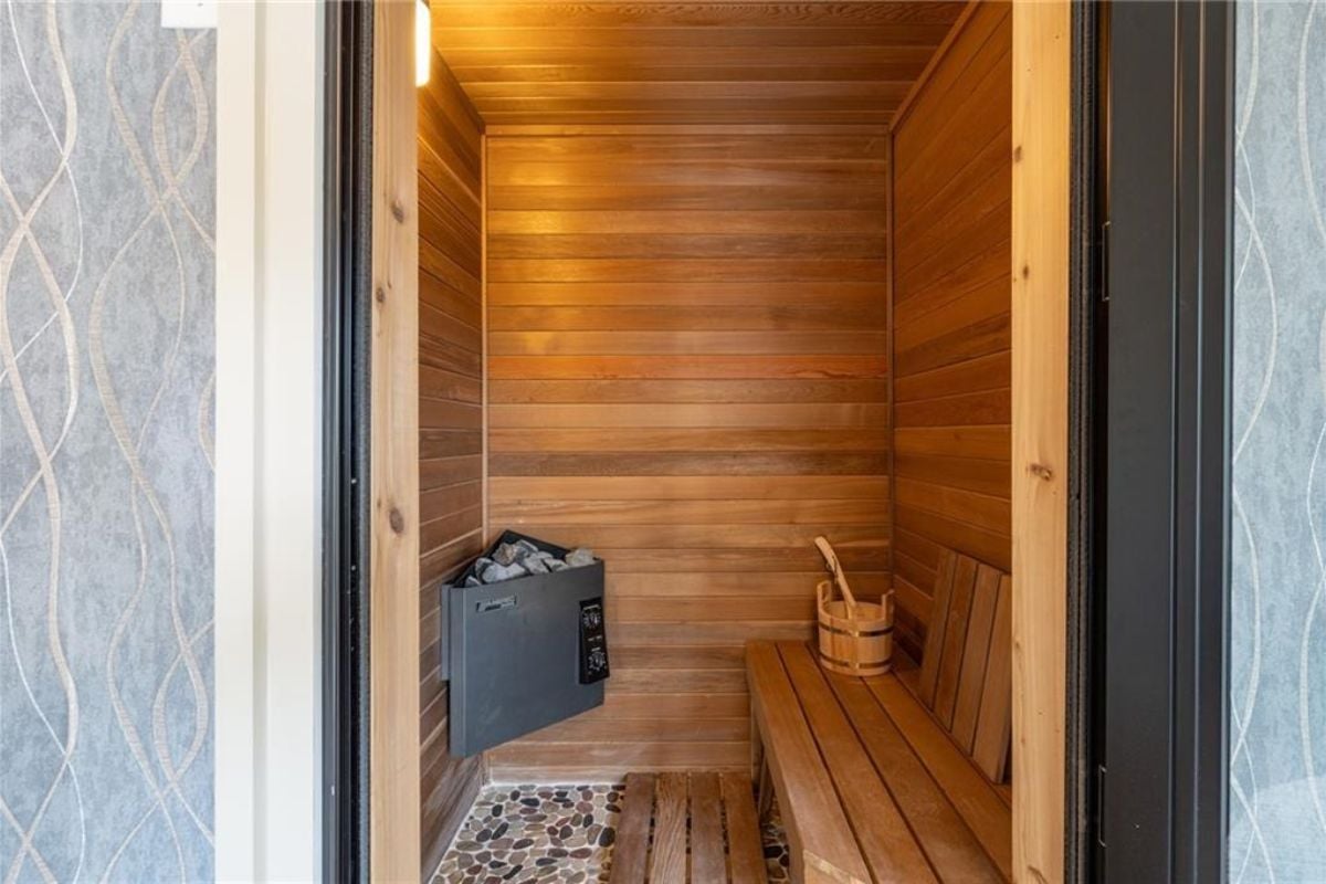 A sauna with a wooden bench and wooden walls.