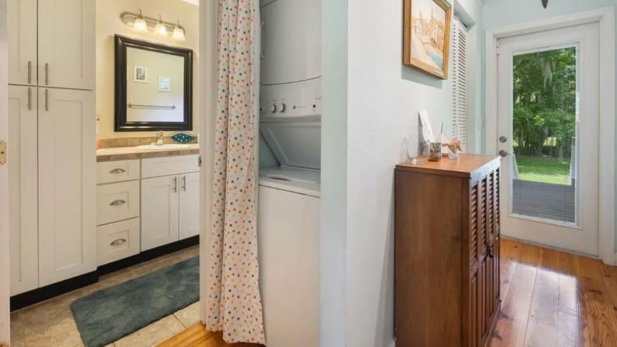 A laundry room with cabinets and a washing machine.