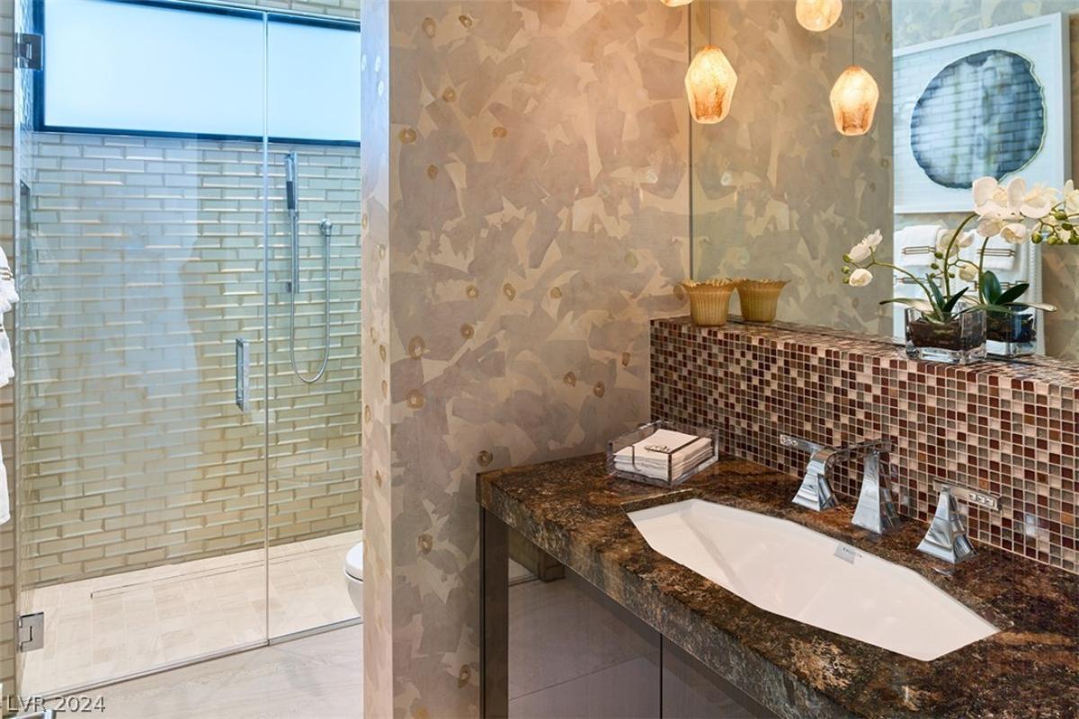 Bathroom with a sink, toilet and a walk-in shower.