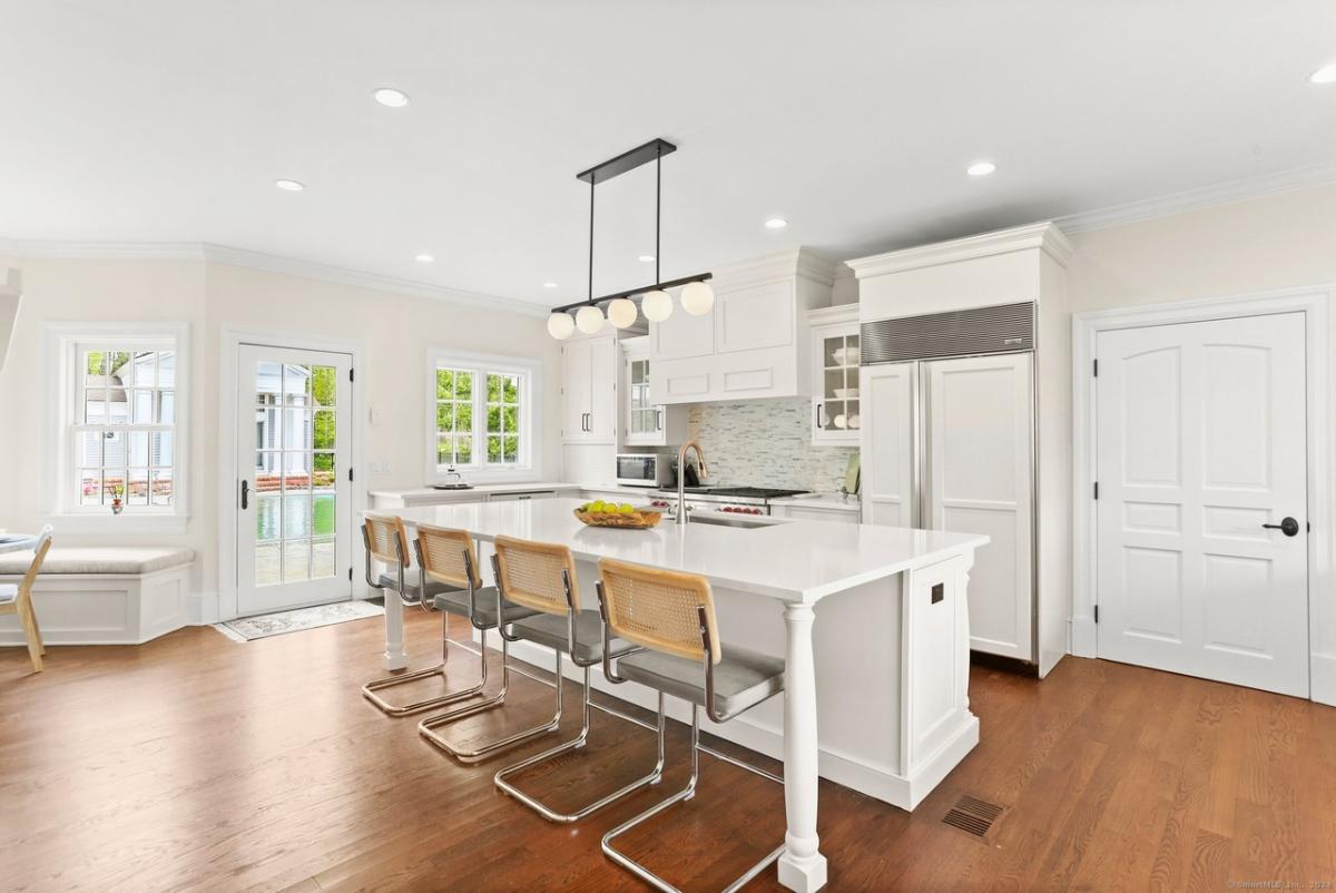 Kitchen with custom cabinetry and a counter breakfast bar.
