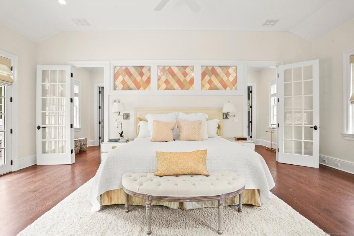 Bedroom with a large bed and hardwood floors.