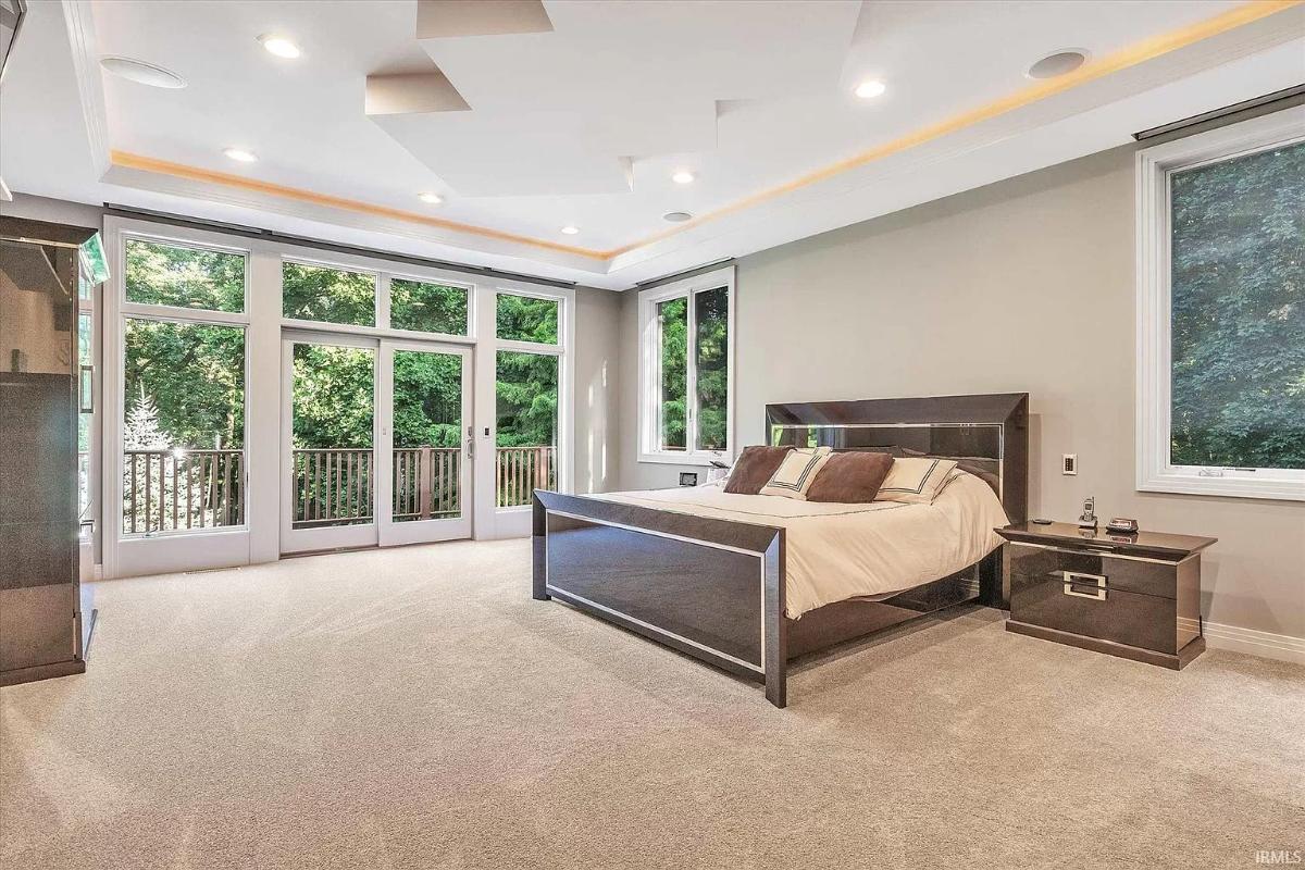 Bedroom with carpet flooring and glass doors.