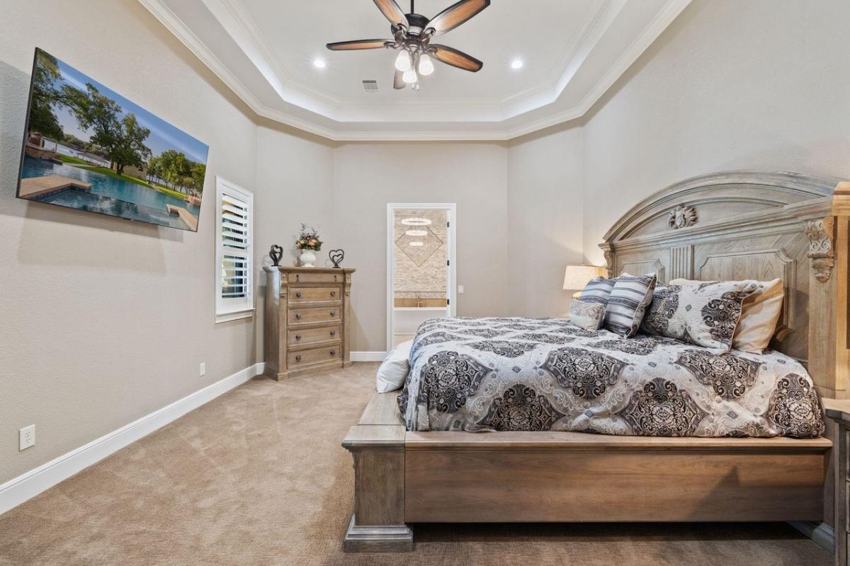 Bedroom with a large bed and carpet flooring.