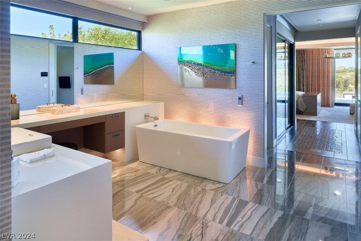 Bathroom with a sink and a soaking tub.