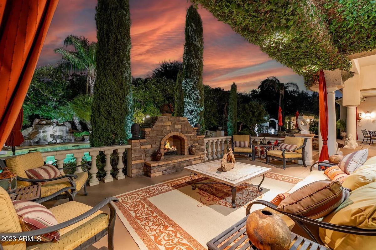 Outdoor living space with a fireplace.