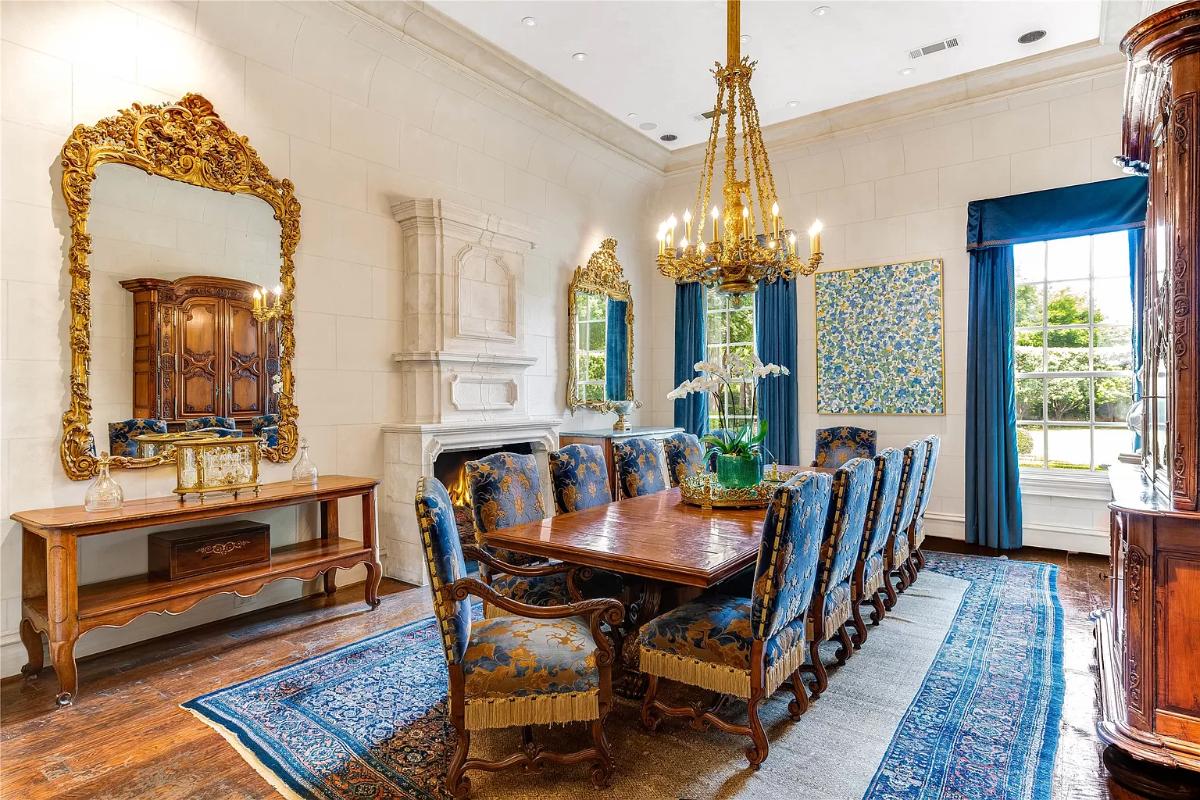 Dining room with a chandelier and a fireplace.
