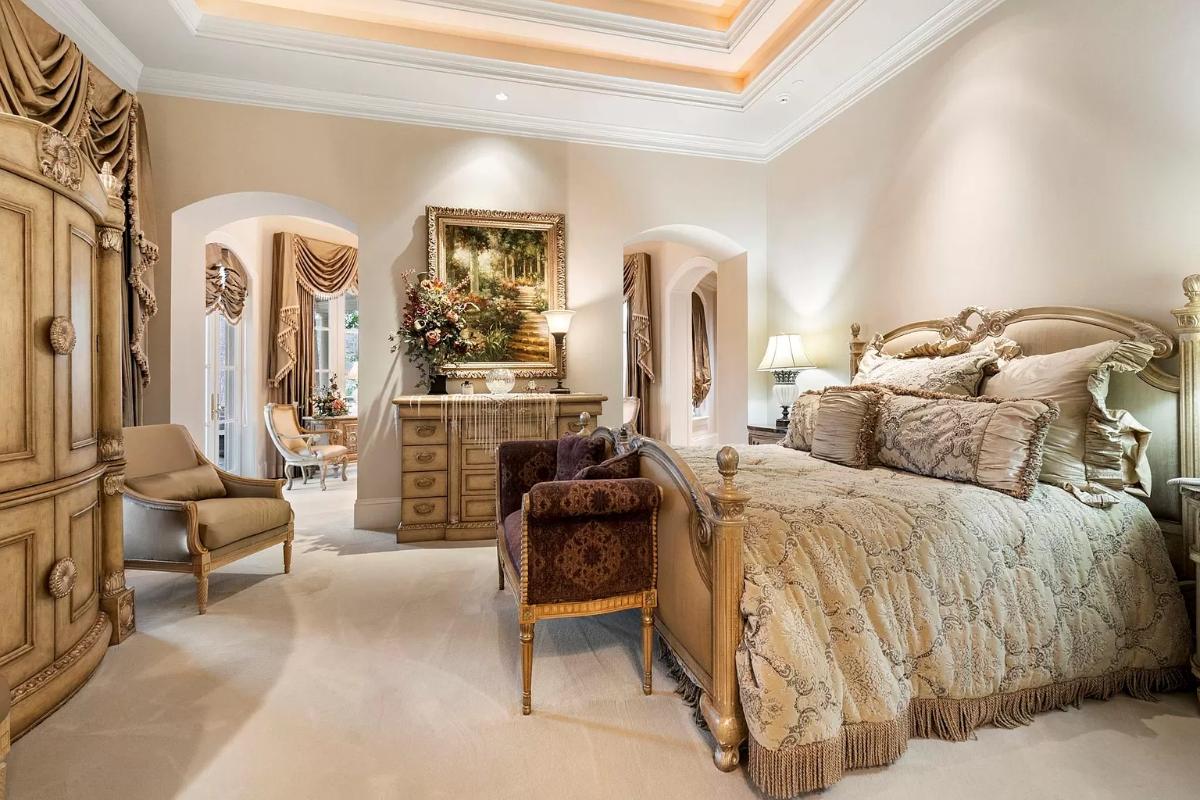 Bedroom with a large bed and carpet flooring.