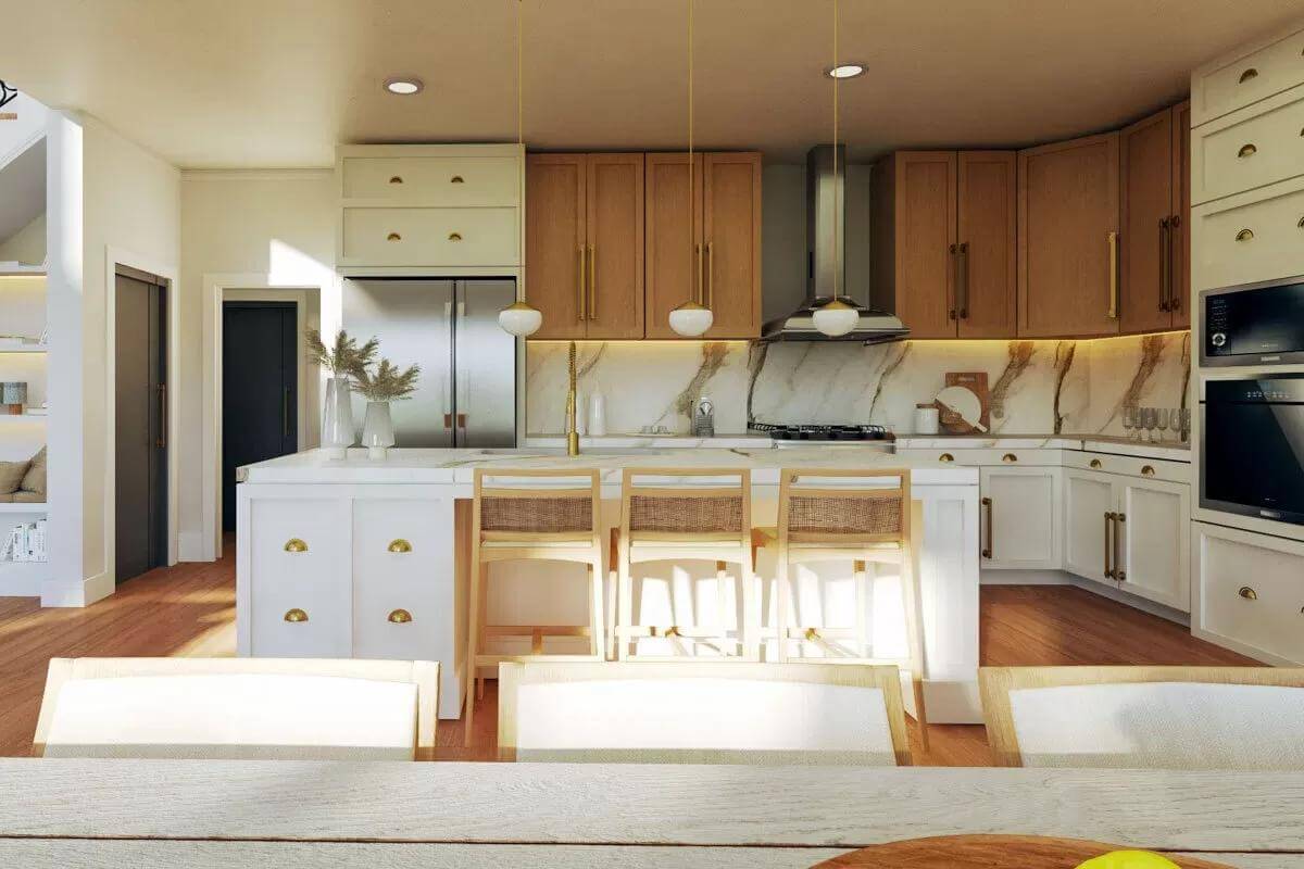 Kitchen with white and wood cabinets and a breakfast island with seating for three.