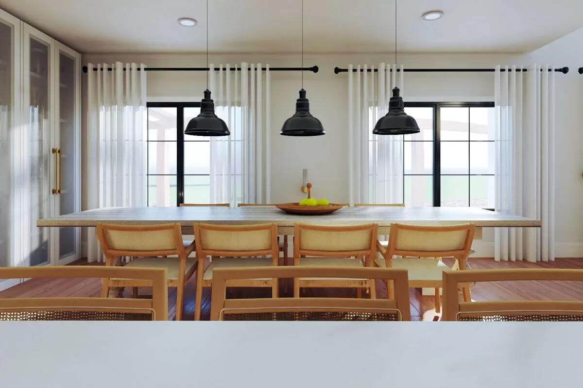 Dining area with a rectangular dining set topped by black dome pendants.