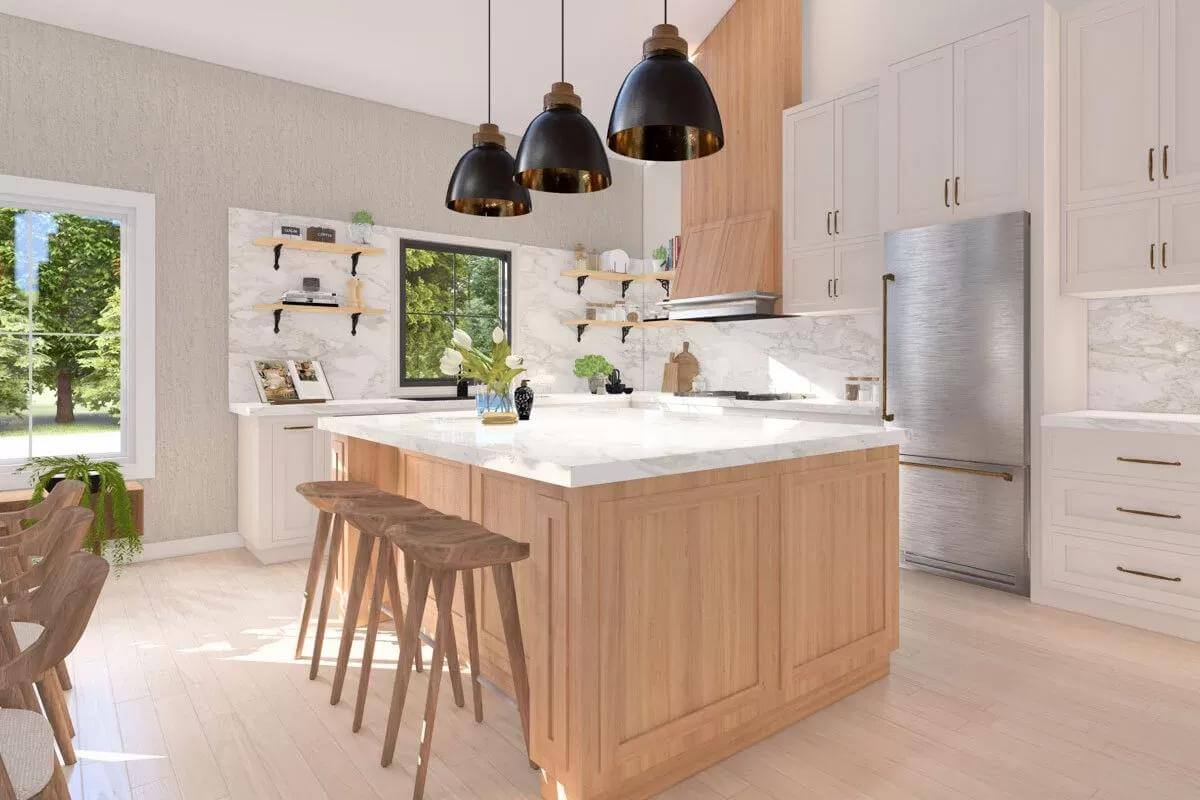 Kitchen with white cabinetry and a breakfast island topped by dome pendants.