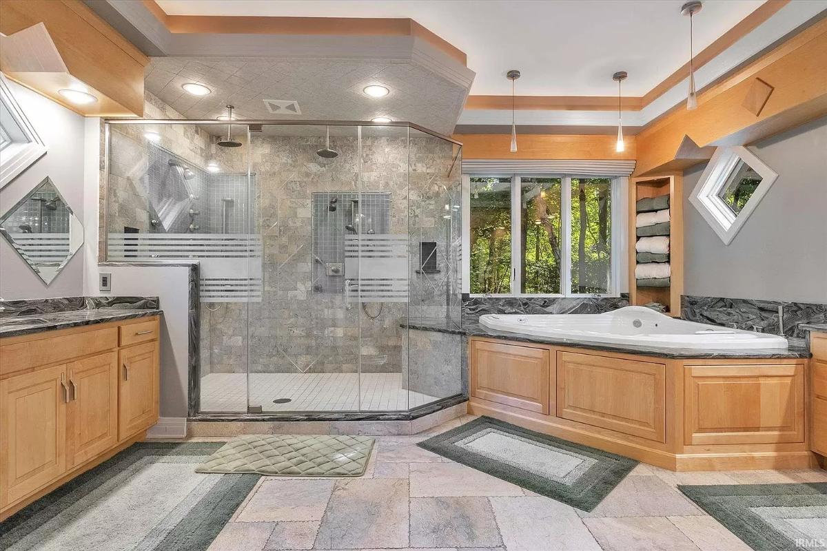 Bathroom with a sink, soaking tub and a walk-in shower.