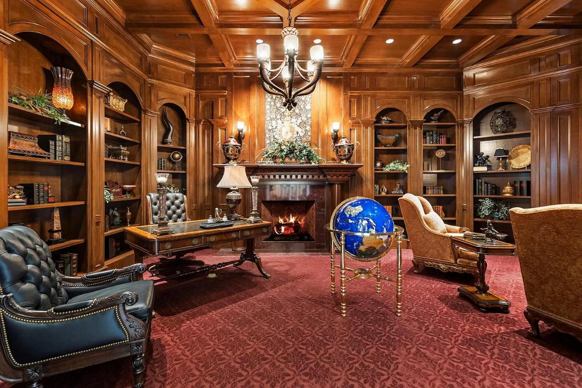 Home office with carpet flooring and coffered ceilings.