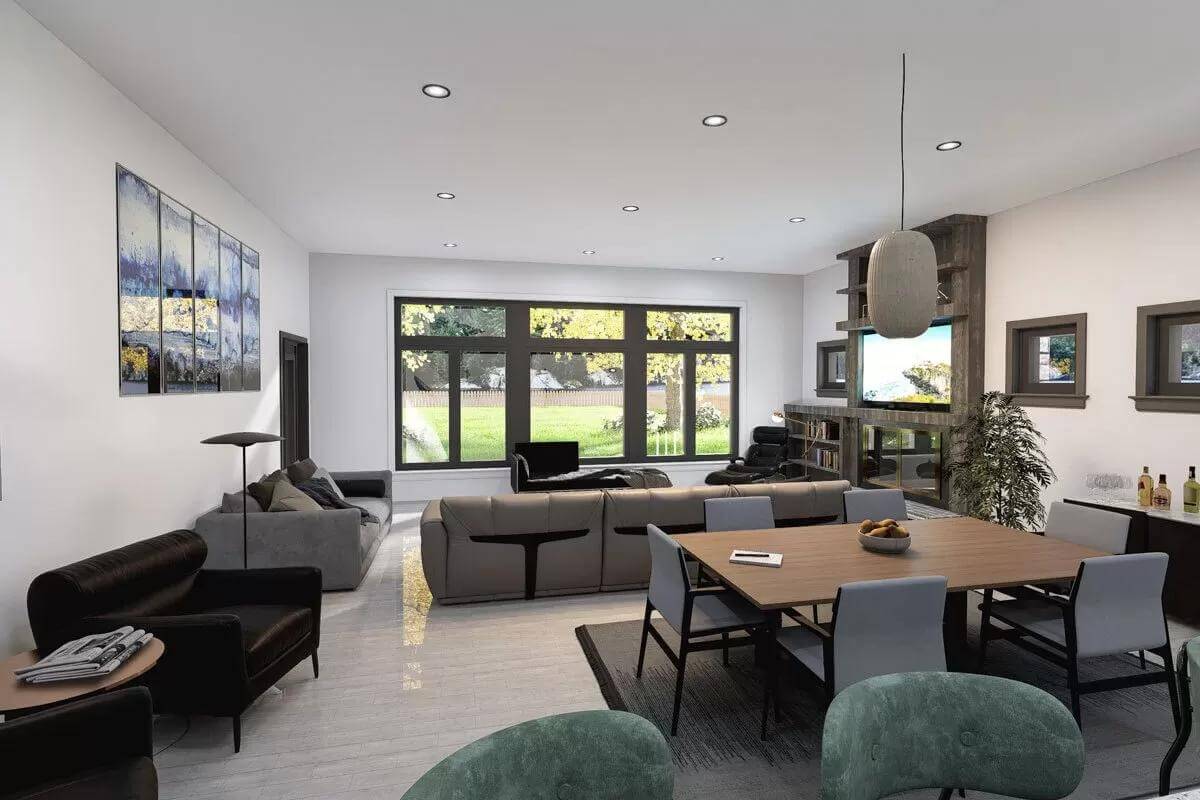 Dining area and great room brightened by recessed ceiling lights and large windows.