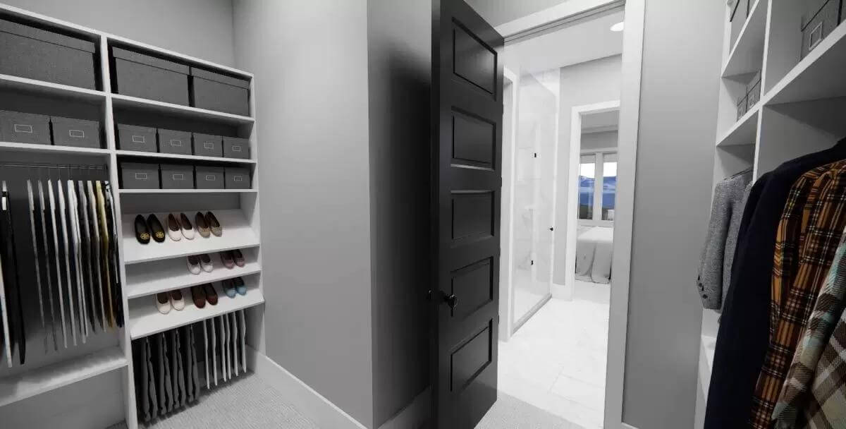 Primary walk-in closet with ample storage and gray walls.