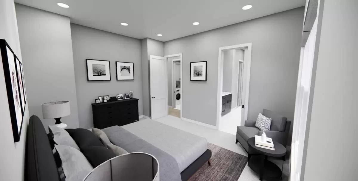 Primary bedroom with a platform bed, a gray chair, and an ensuite bathroom.