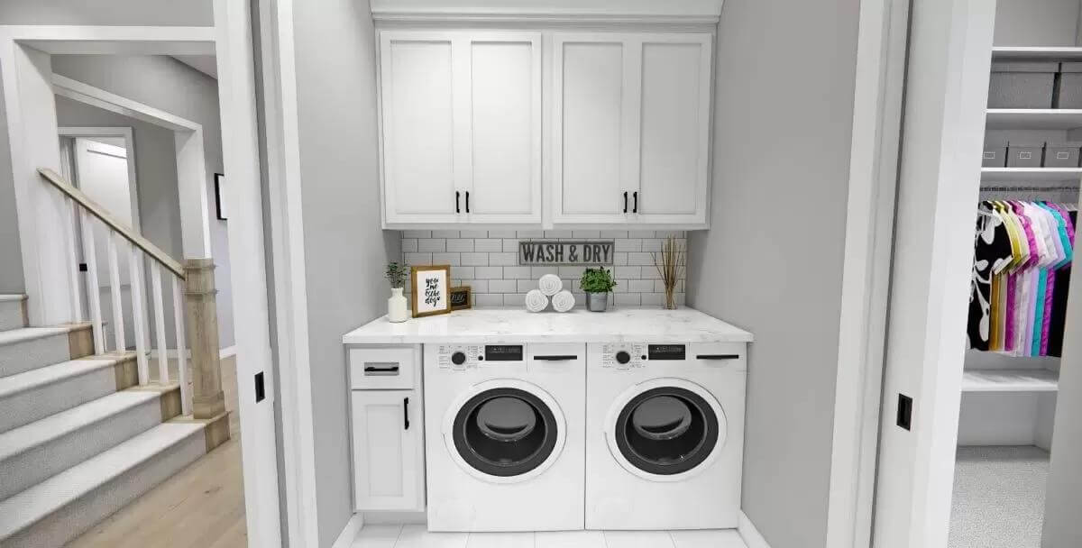 Laundry room with overhead cabinets and a marble counter.