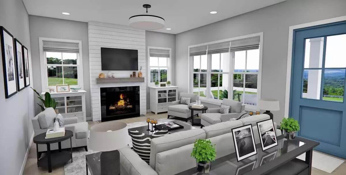 Great room with gray seats and a fireplace topped by a wall-mounted TV.
