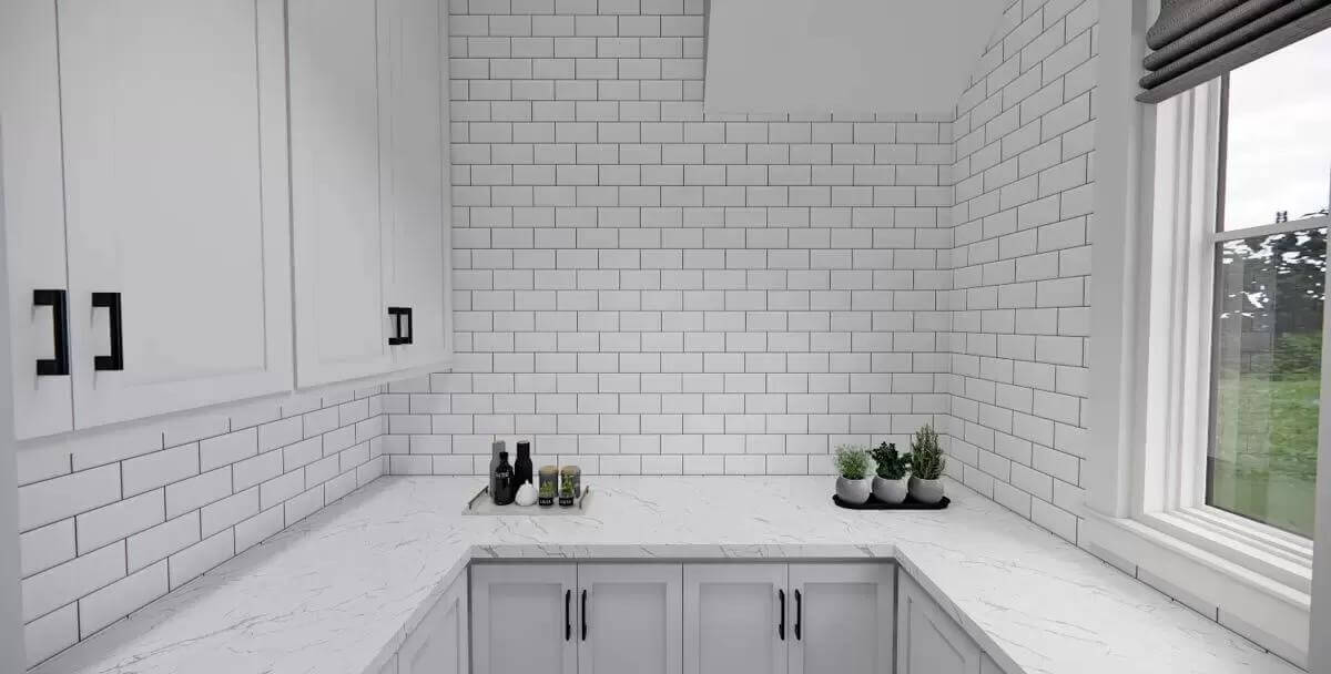 Pantry with marble countertops and a subway tiled backsplash.