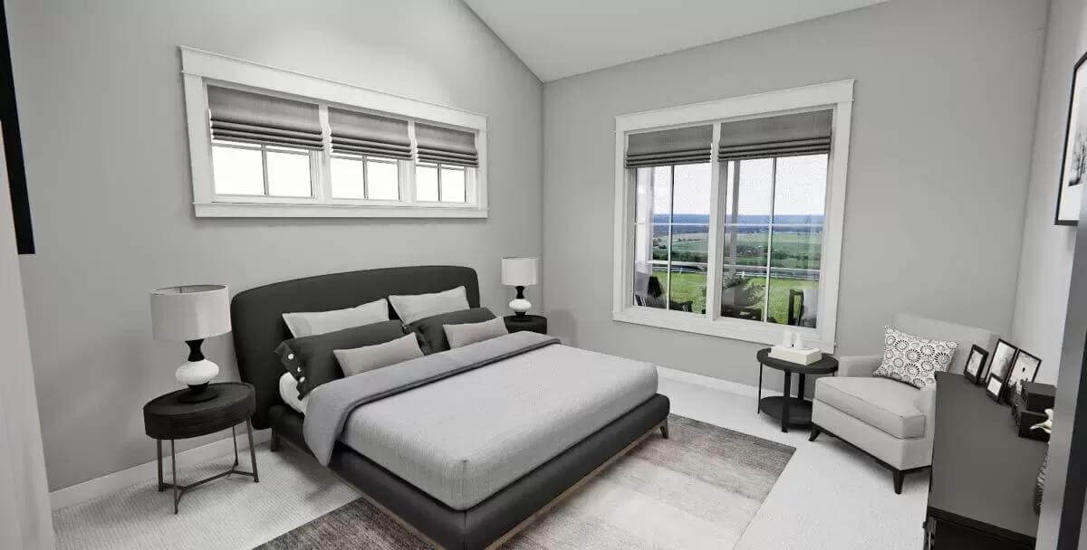 Primary bedroom with a platform bed and a cushioned chair under a cathedral ceiling.