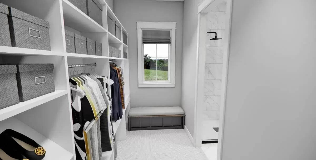Primary walk-in closet with built-in cubbies and a storage bench under the small window.