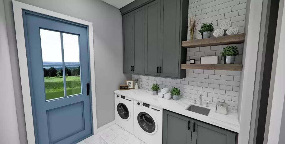 Laundry room with gray cabinets, a marble countertop, and outdoor access via a glazed door.