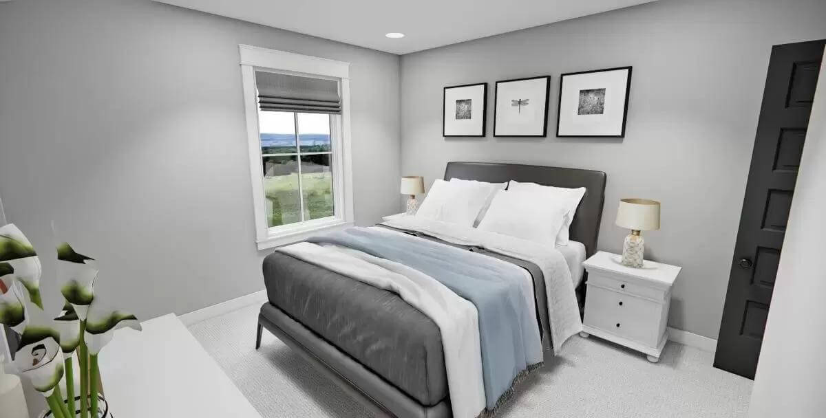 Bedroom with a platform bed adorned by black-framed artworks.