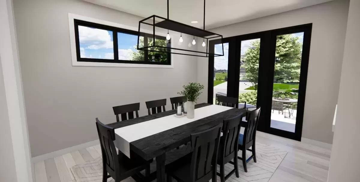 Dining room with a black dining set illuminated by a linear chandelier and clerestory windows.