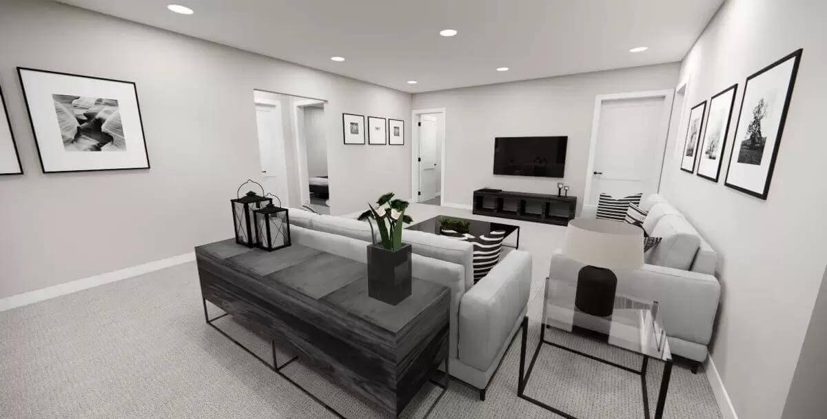 Living room with gray sofas, iron tables, and a wall-mounted TV.