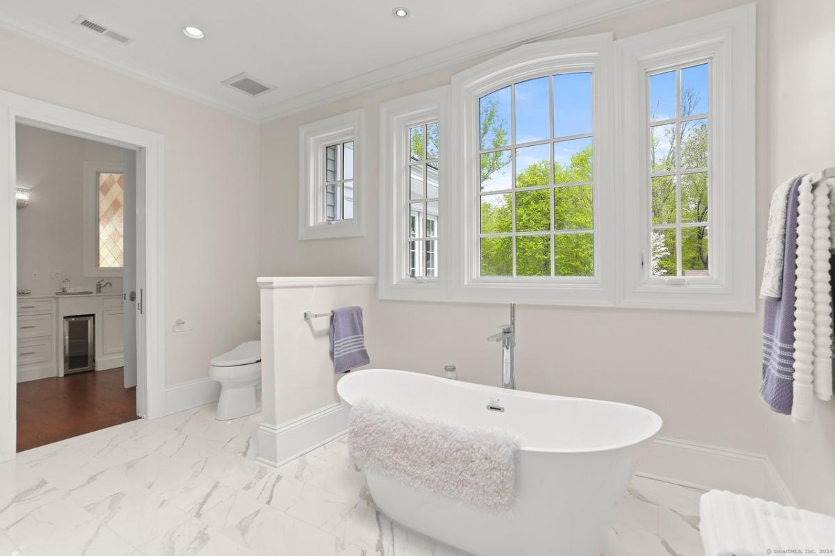 Bathroom with a toilet and a soaking tub.