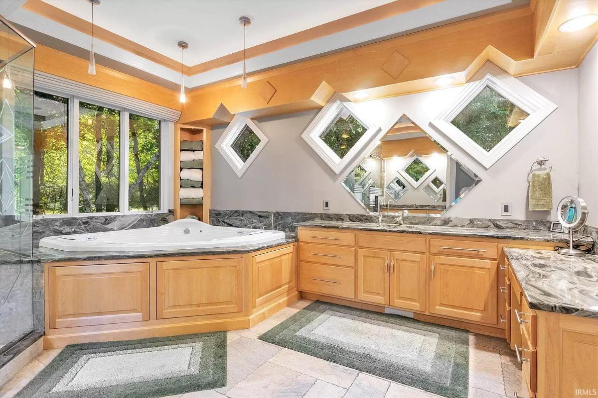 Bathroom with a sink, soaking tub and a walk-in shower.