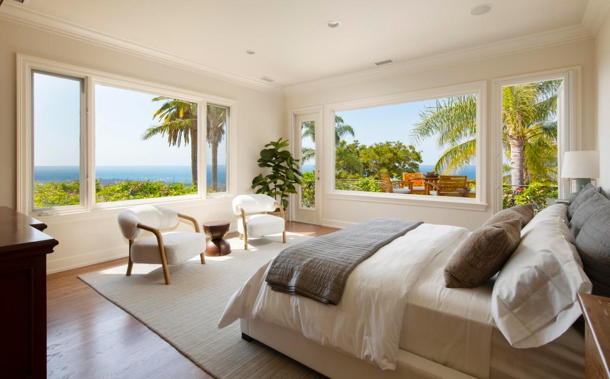 Bedroom with hardwood floors and glass windows.