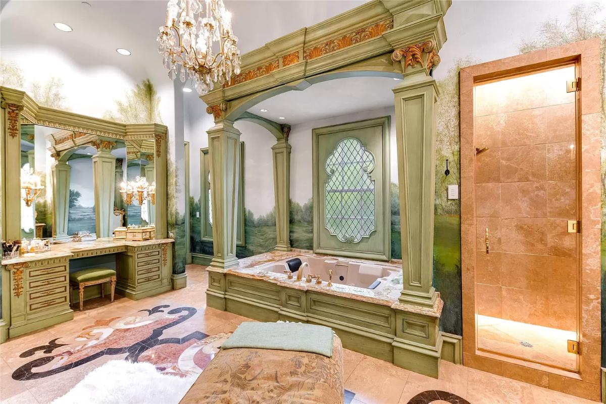 Bathroom with a chandelier, soaking tub and a walk-in shower.