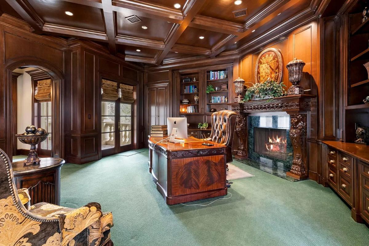 Home office with carpet flooring and coffered ceilings.