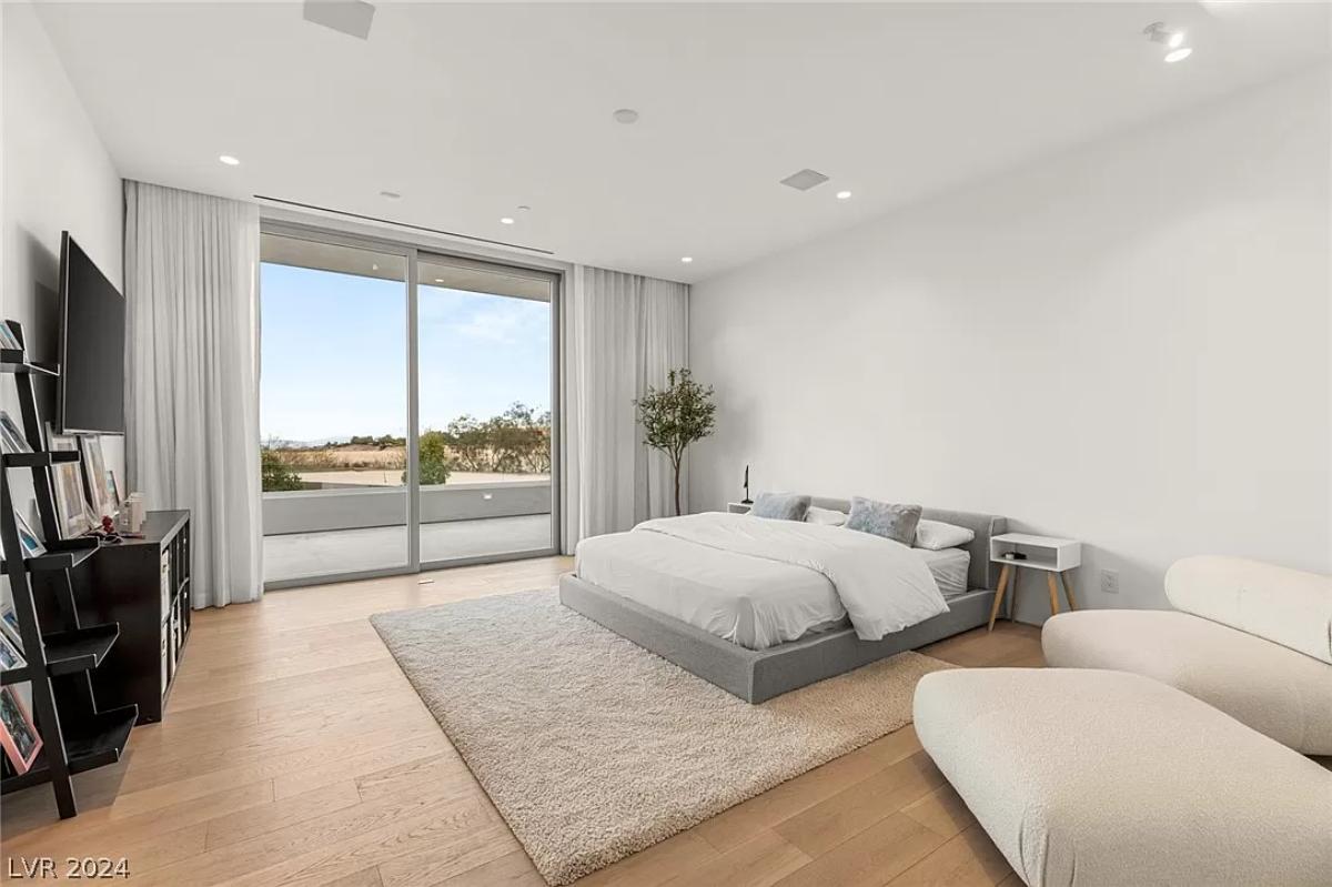 Bedroom with hardwood floors and sliding glass doors.