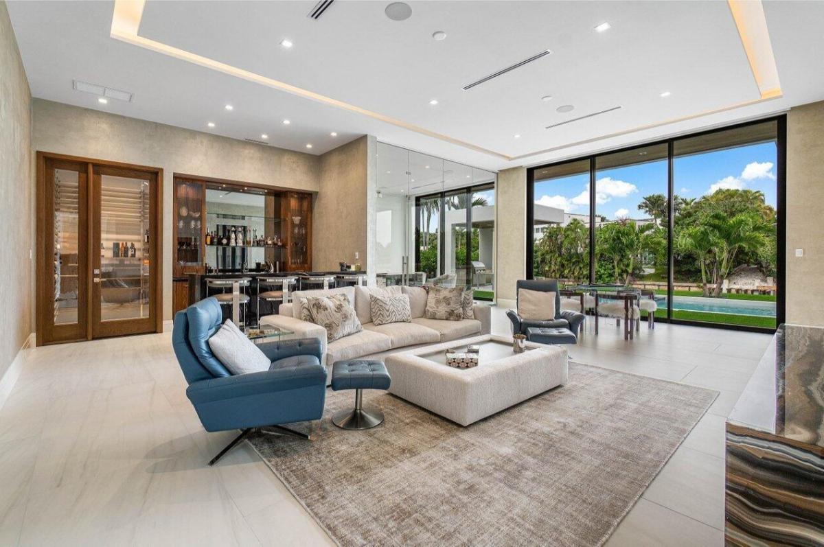 Living room with couches and custom lighting.